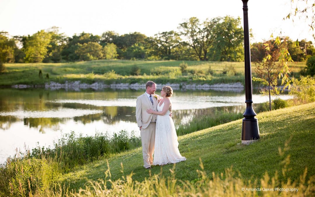 Bride and Goom standing by pond