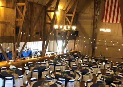 round tables set for a reception inside the Big Red Barn viewed from above