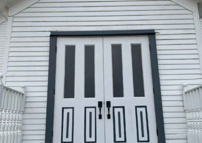 view of chapel doors from the ground outside