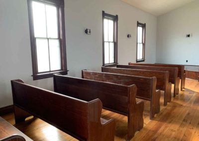 view of south pews and windows from rear of chapel