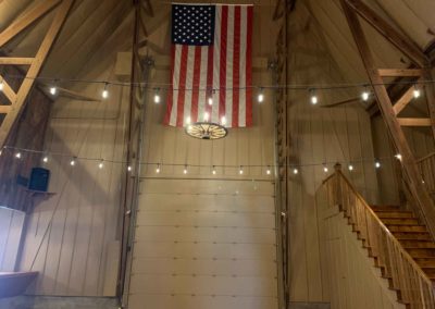 large American flag above the east door in the Big Red Barn