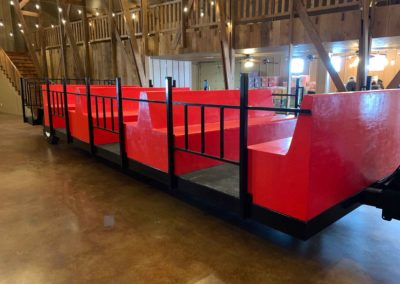 large custom trailer to transport guests to and from the church in the Big Red Barn